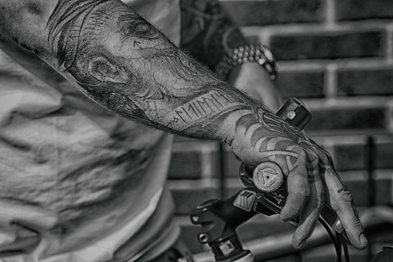 arm, hand, bike, steering wheel, tattoo, adult, gray bike, tattoo, tattoo, tattoo, tattoo, tattoo