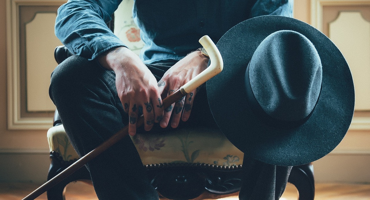man, sitting, cane, old, hat, white, guy, waiting, people, hands, tattoos, chair, seat, pants, shirt, blue old, cane, cane, cane, cane, cane, waiting, waiting