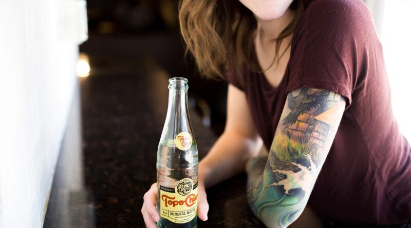 beverage, body art, bottle, drink, fashion, girl, happy, indoors, leisure, nature, mineral water, person, refreshment, smile, topo chico, water