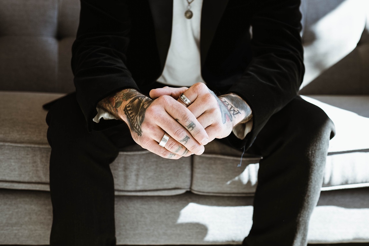 guy, man, rings, hands, fingers, couch, sofa, sitting, necklace, tattoos, sunlight, black, guy, necklace, necklace, necklace, necklace, necklace, tattoos, tattoos